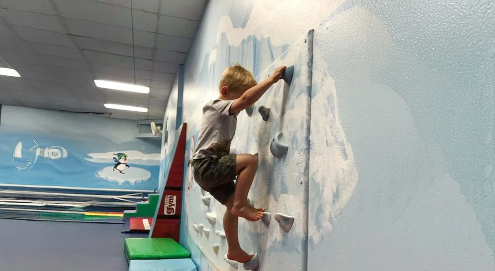 A child on the Precision climbing wall