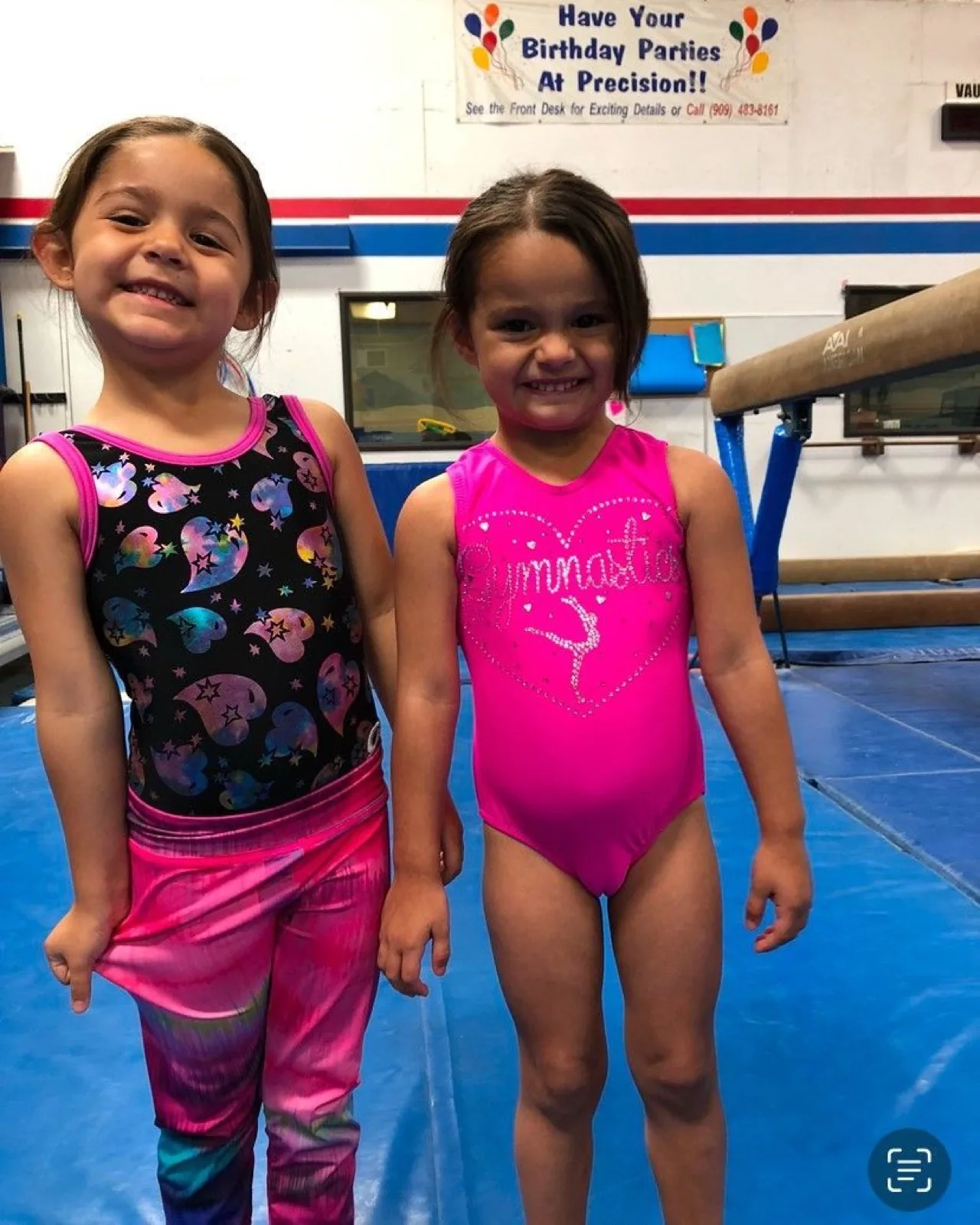 Two smiling preschool gymnasts in leotards at Precision