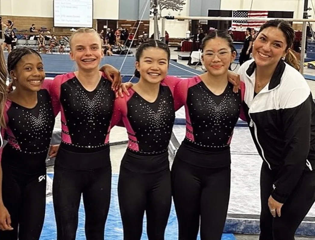Precision competitive team gymnasts with their coaches